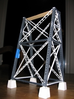 This photo of the an assembled and unpainted tower shows the custom sway braces in white. Notice how there are two widths with one direction fitting inside the other.