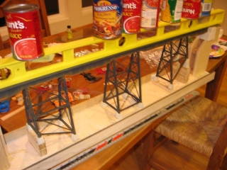 A few cans of vegetables worked great to hold the trestle steady while the epoxy under the foundation piers set.