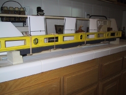 The track deck and girder assembly is protected and held in alignment with rubber bands around a plastic level.
